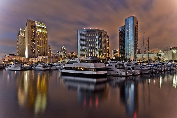 A photo of the harbor and skyline of San Diego in the evening.